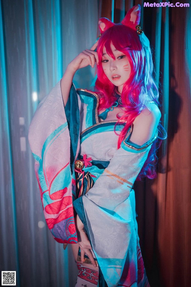 A woman with pink hair wearing a kimono and cat ears.